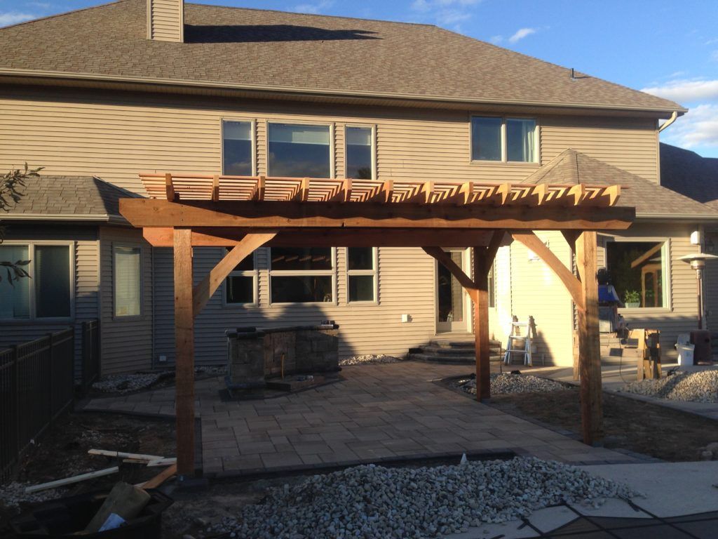 A house with a wooden pergola i