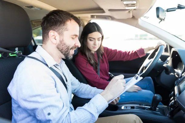 Professional Driving Instructor Assessing Student Driver