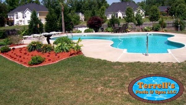 A large swimming pool with a sign that says terrell 's