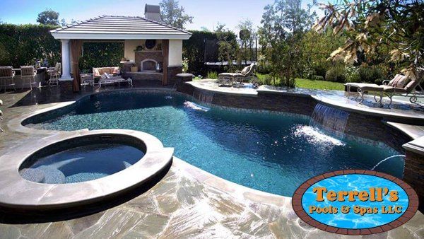 A large swimming pool is surrounded by a terrall 's sign