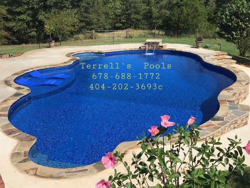 A large swimming pool with a phone number for terrell 's pools
