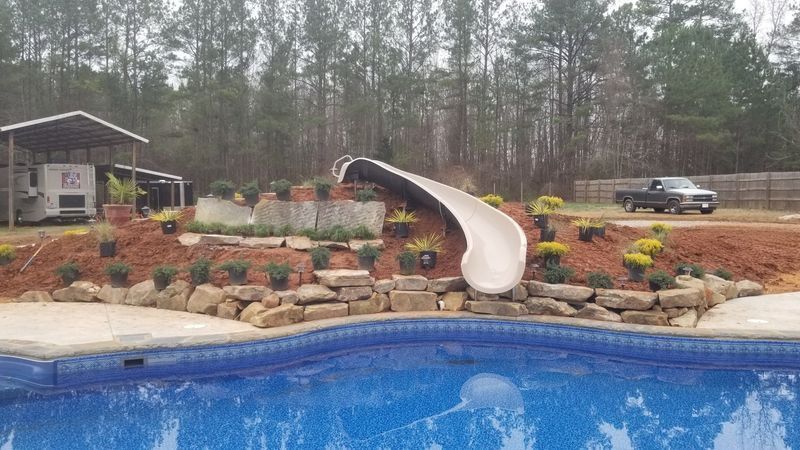 A swimming pool with a slide in the middle of it.