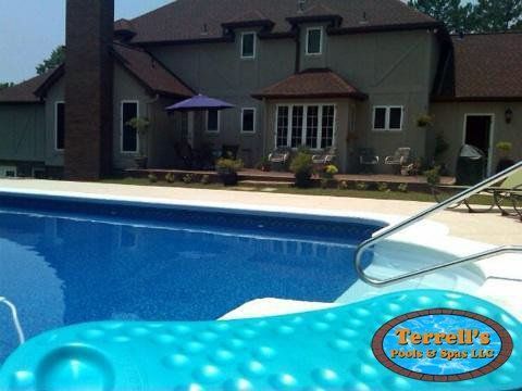 A large house with a large swimming pool in front of it