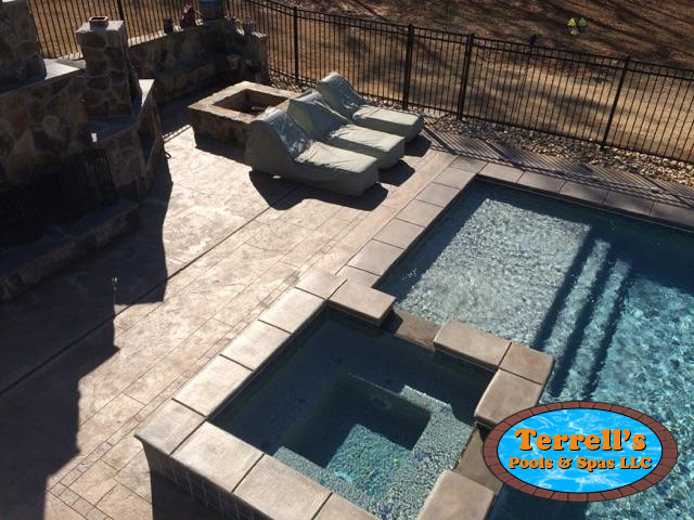 An aerial view of a swimming pool with a sign that says terrell 's pool & spa llc