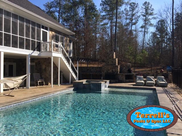 A large swimming pool in the backyard of a house