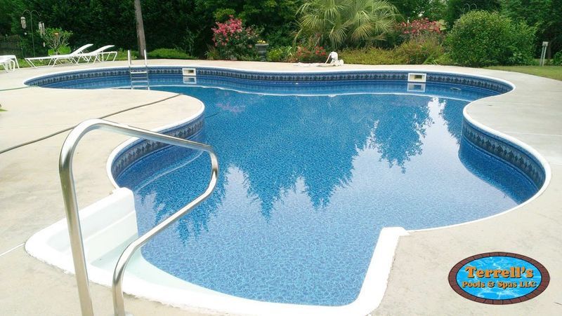 A large swimming pool with a staircase leading to it