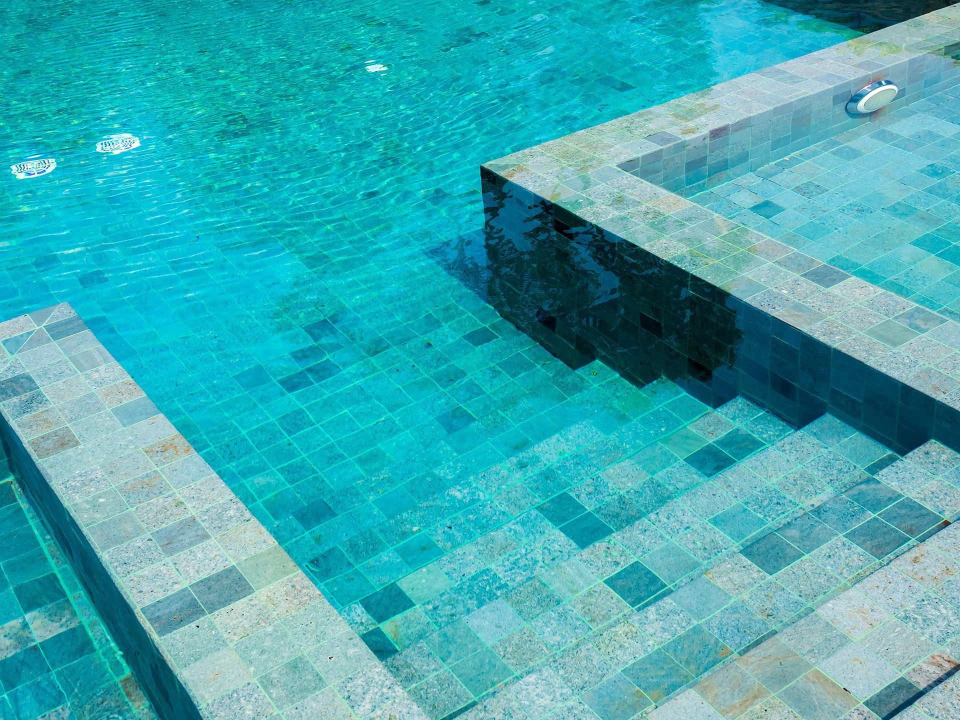 A swimming pool with stairs leading up to it