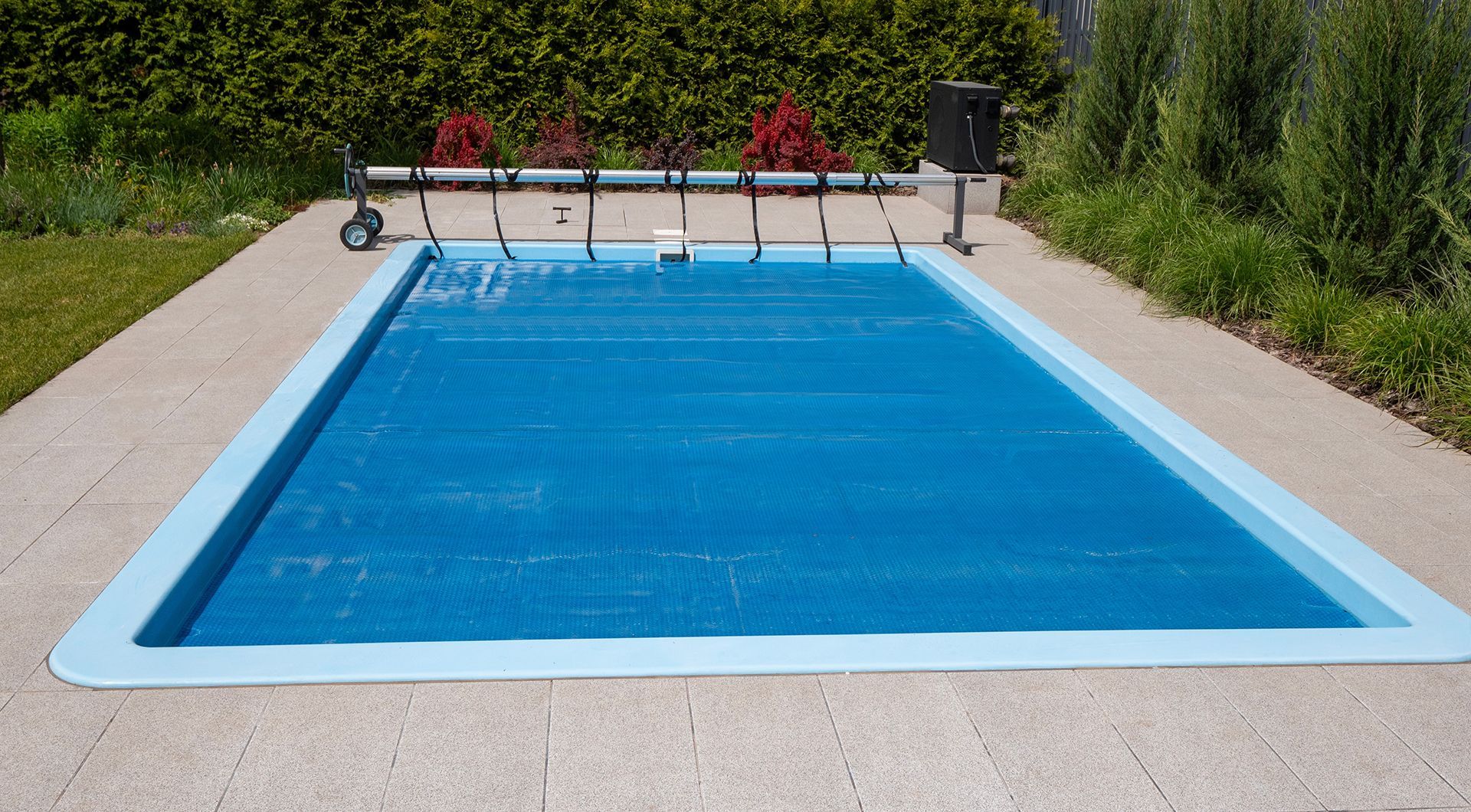 A swimming pool with a blue cover on it