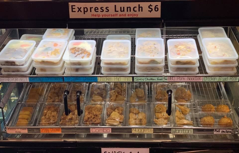 A display case with a sign that says express lunch $ 6