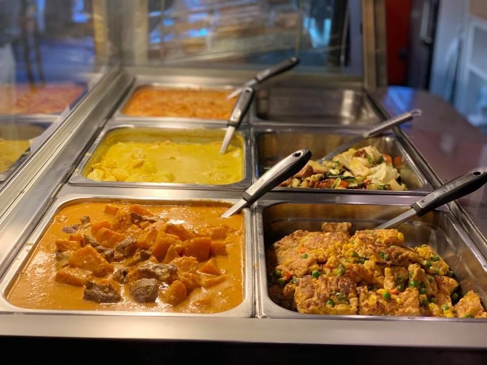 A buffet line filled with lots of different types of food.