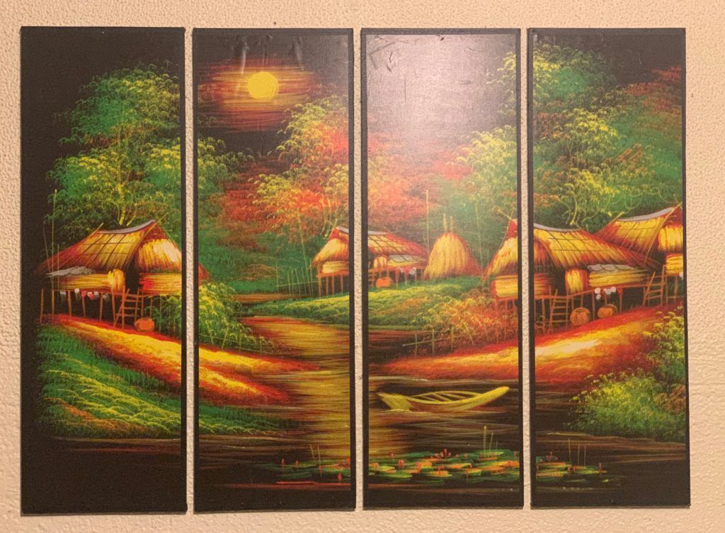 A painting of a village with thatched roofs and a river