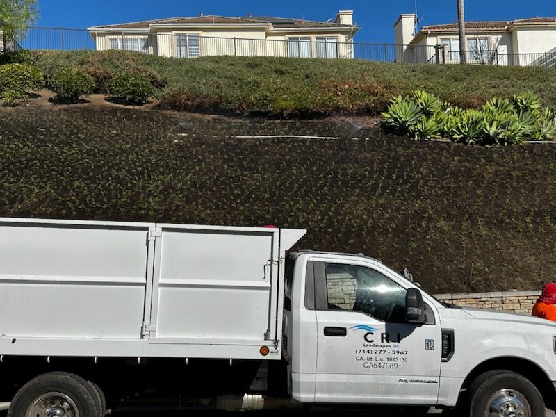 A white truck is parked in front of a house