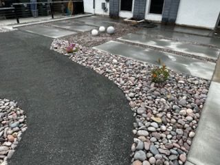 A driveway with a lot of rocks on the side of it