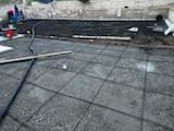 A concrete floor with a vacuum cleaner on it.