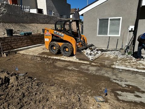 A case skid steer is parked in front of a house.