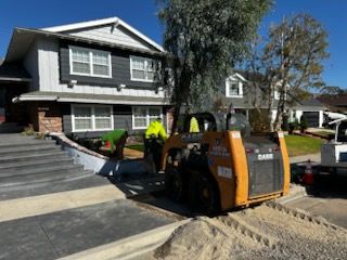 A construction vehicle is parked in front of a house.