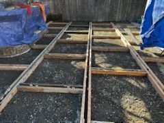 A wooden frame is sitting on top of a dirt ground.
