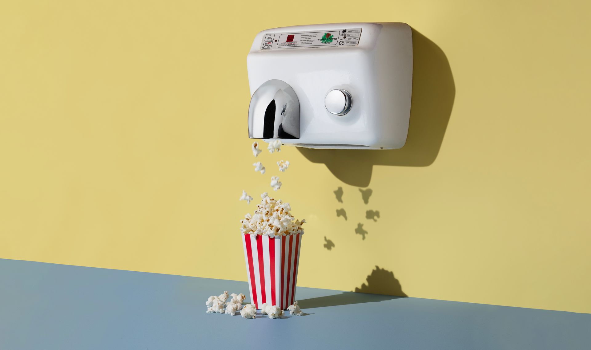A hand dryer with popcorn coming out of it