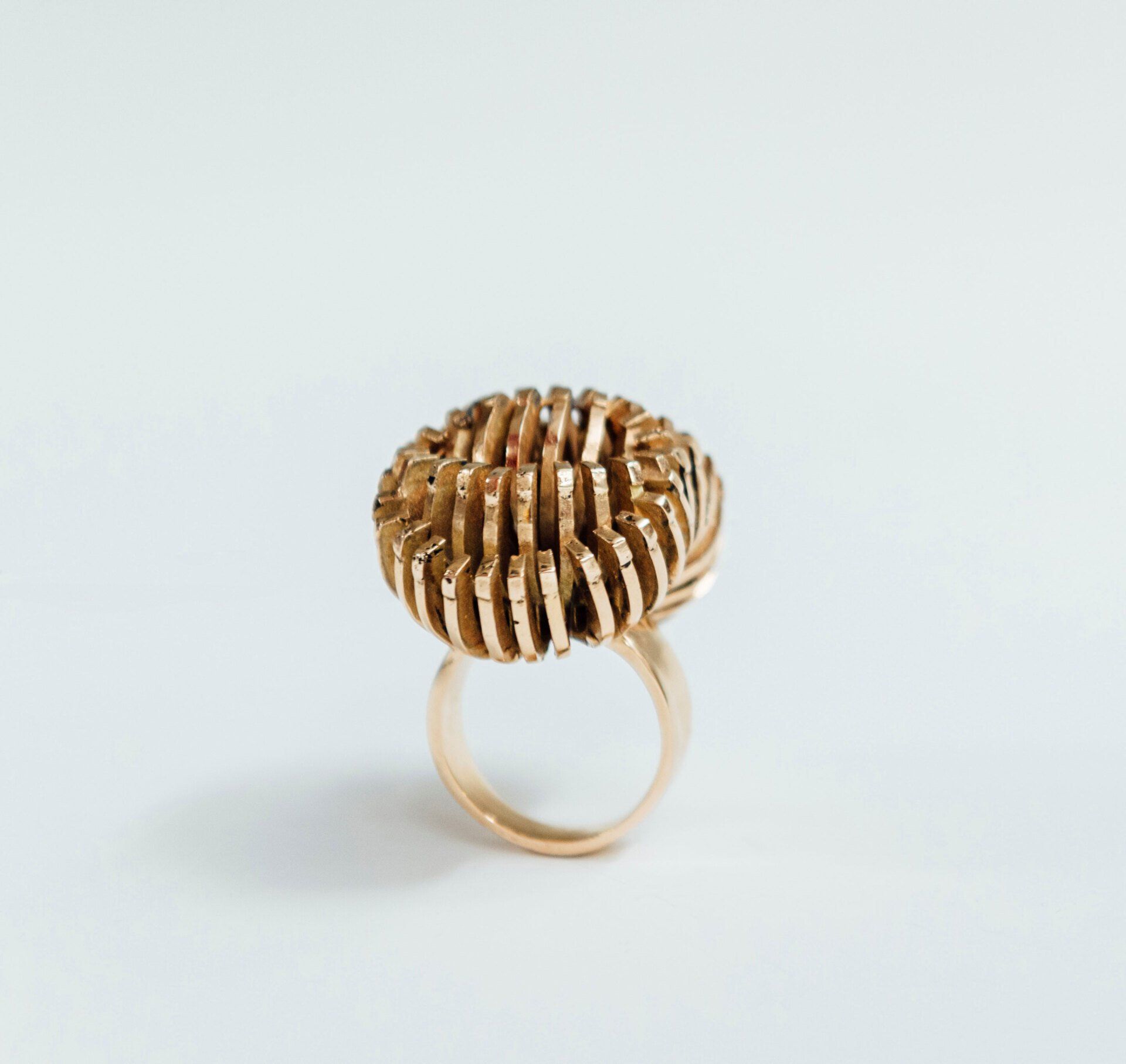 A gold ring is sitting on a white surface