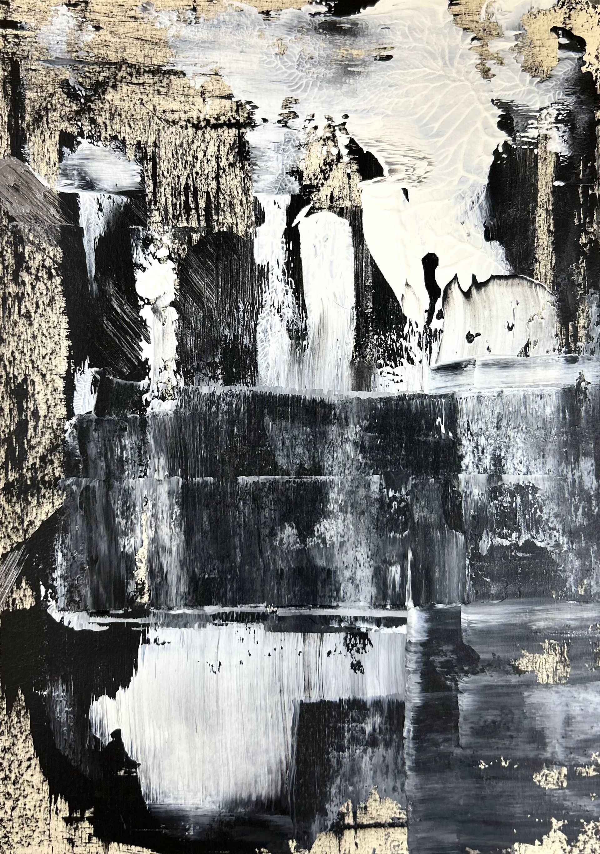 A black and white painting with gold foil on it