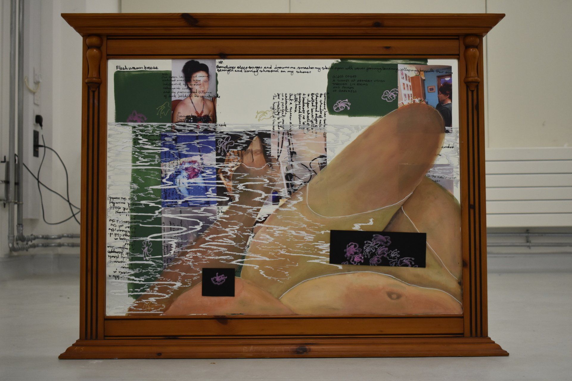 A framed painting of a woman laying on the floor