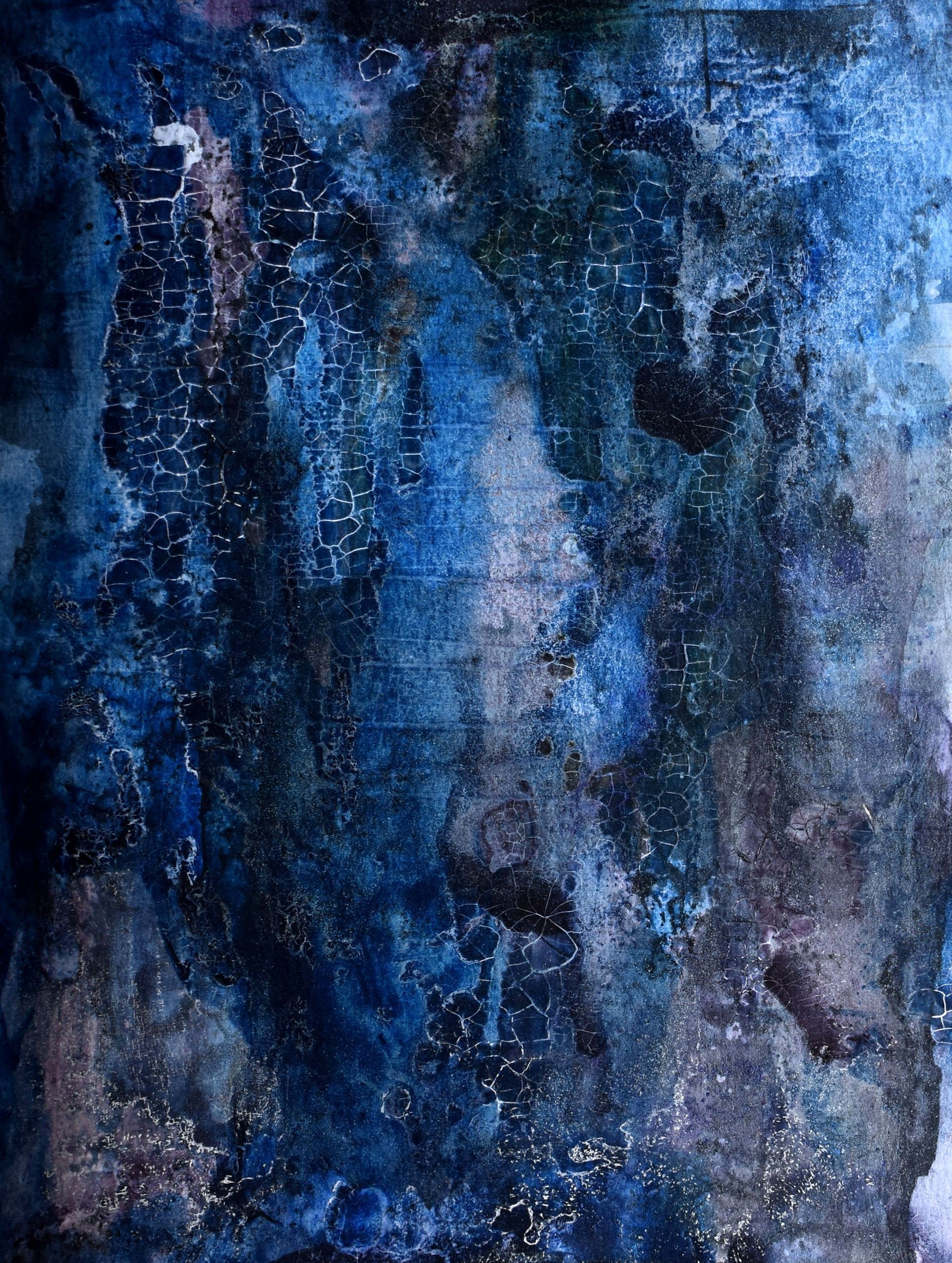 A close up of a blue and black painting