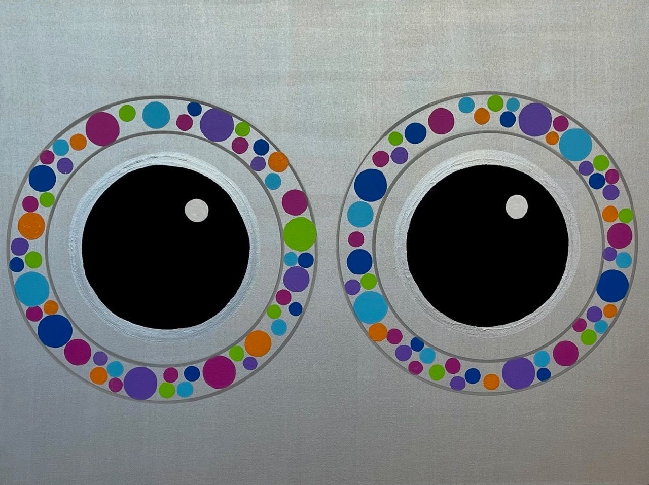 A pair of eyes with colorful circles around them
