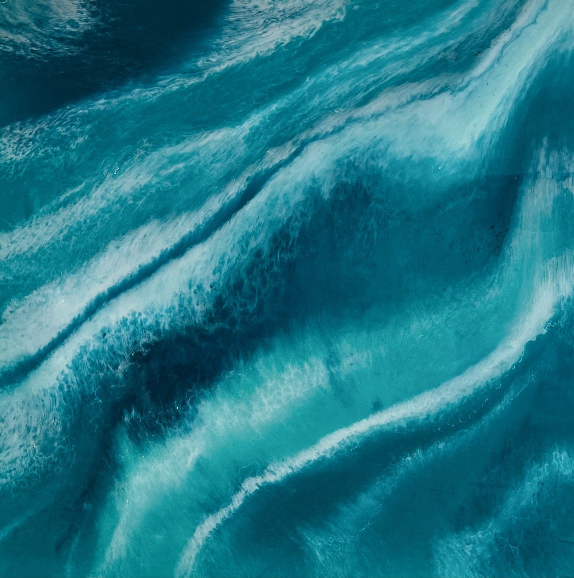 A close up of a blue water surface with waves