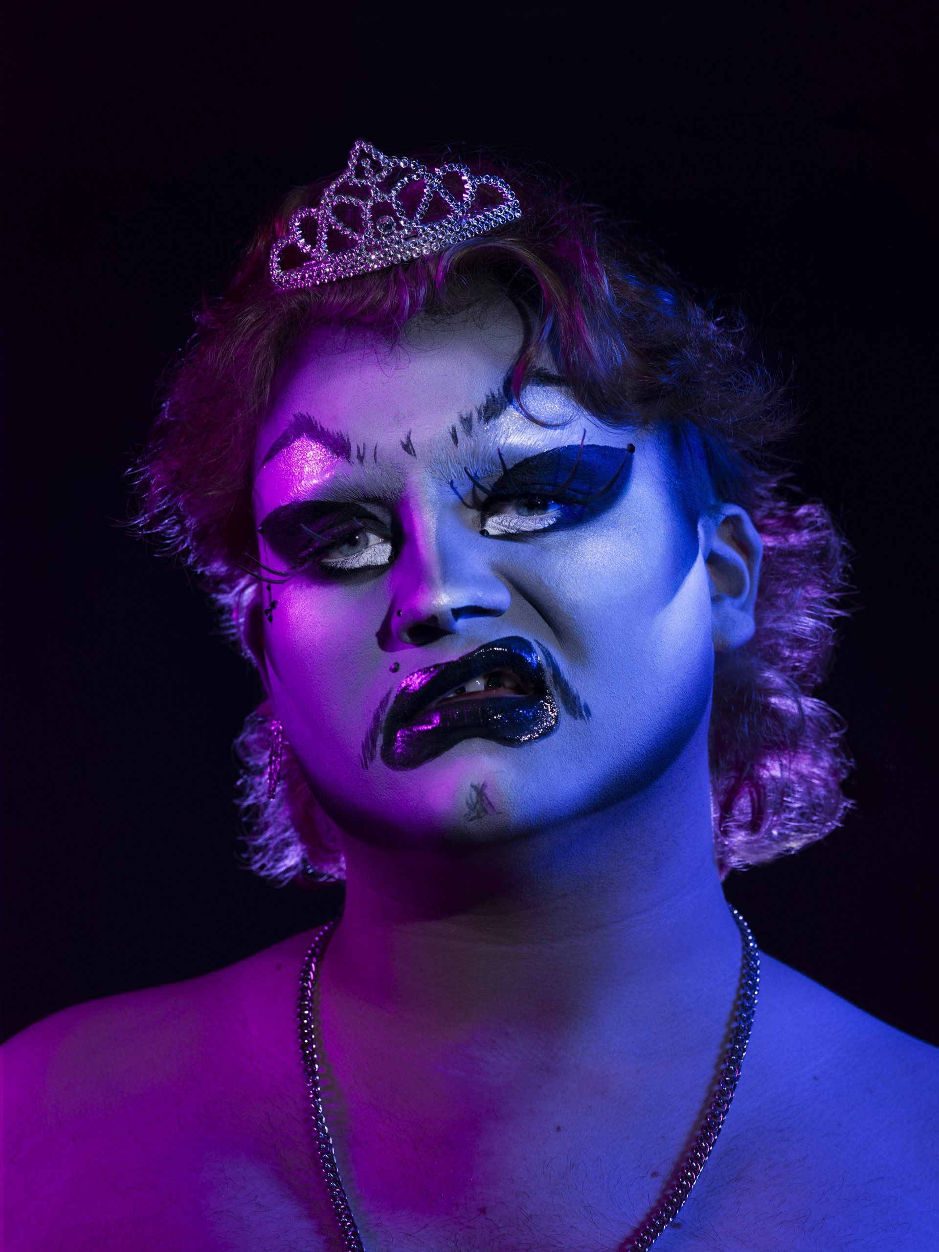 A drag queen with a tiara on her head