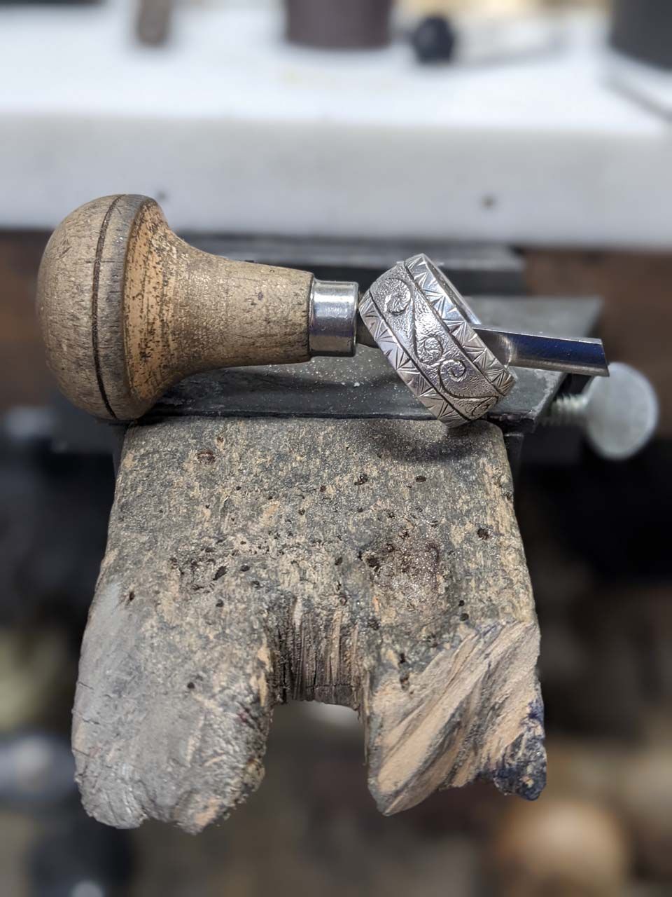 A couple of rings are sitting on top of a piece of wood.