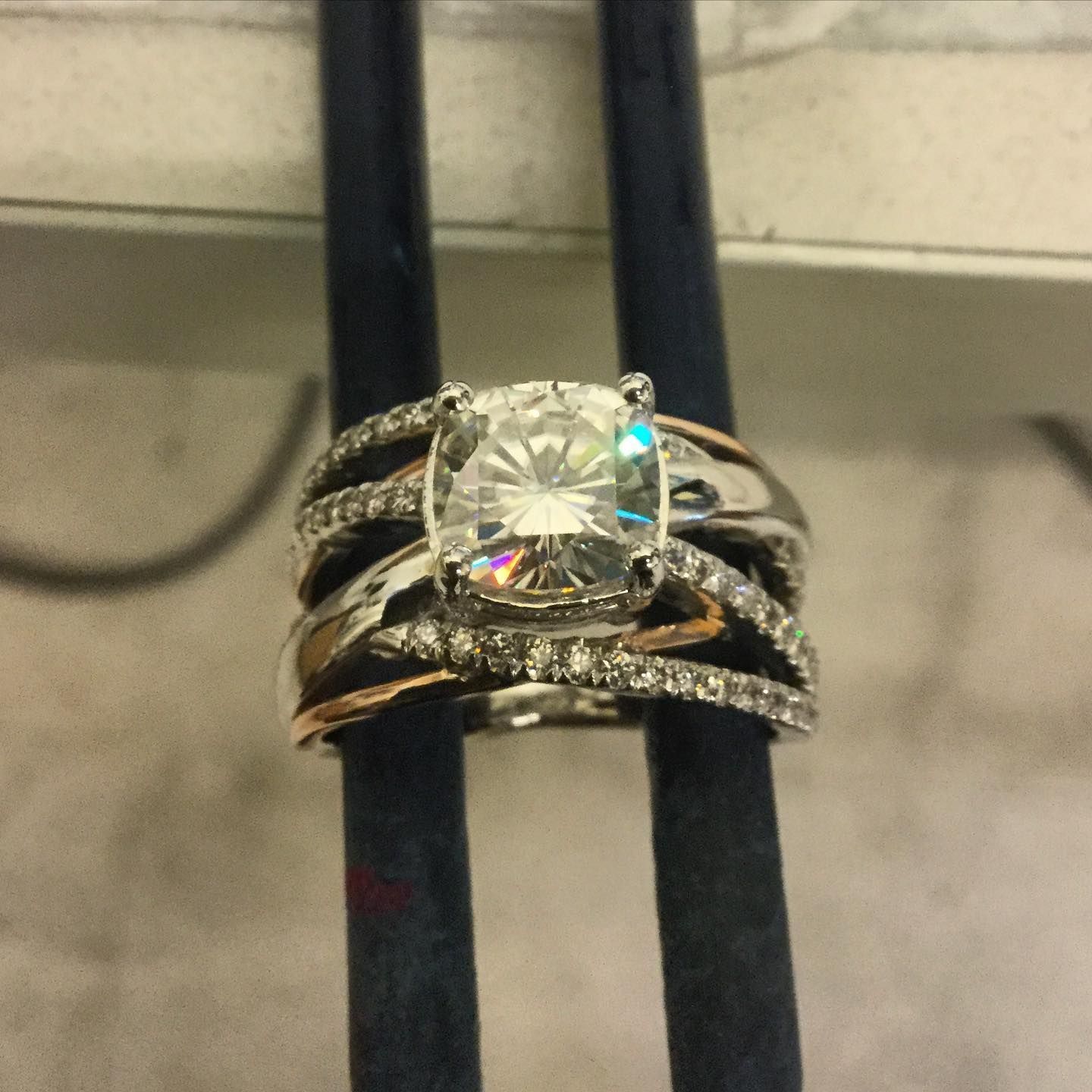 A ring with a diamond in the center is surrounded by other rings