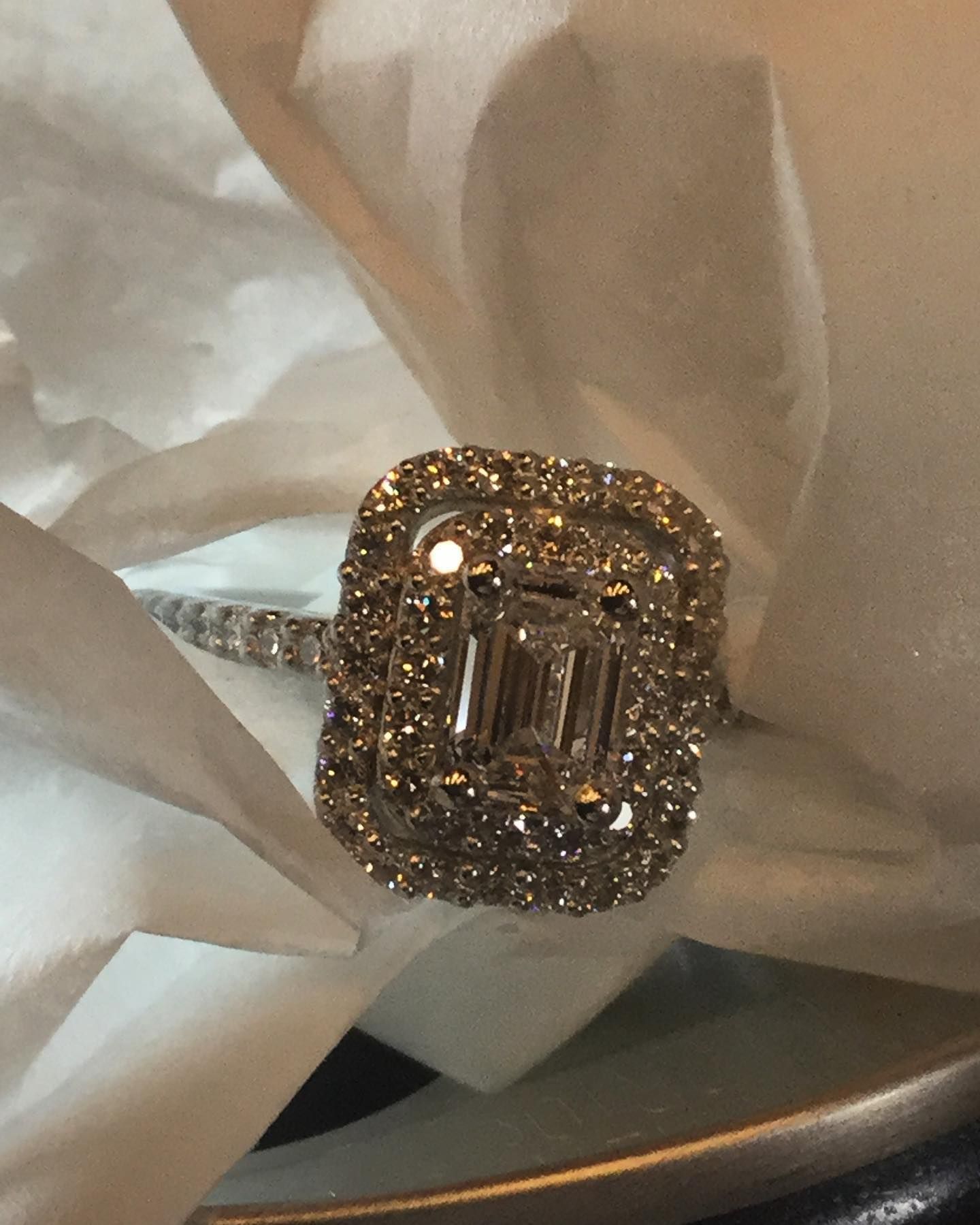 A diamond ring is sitting on a piece of paper