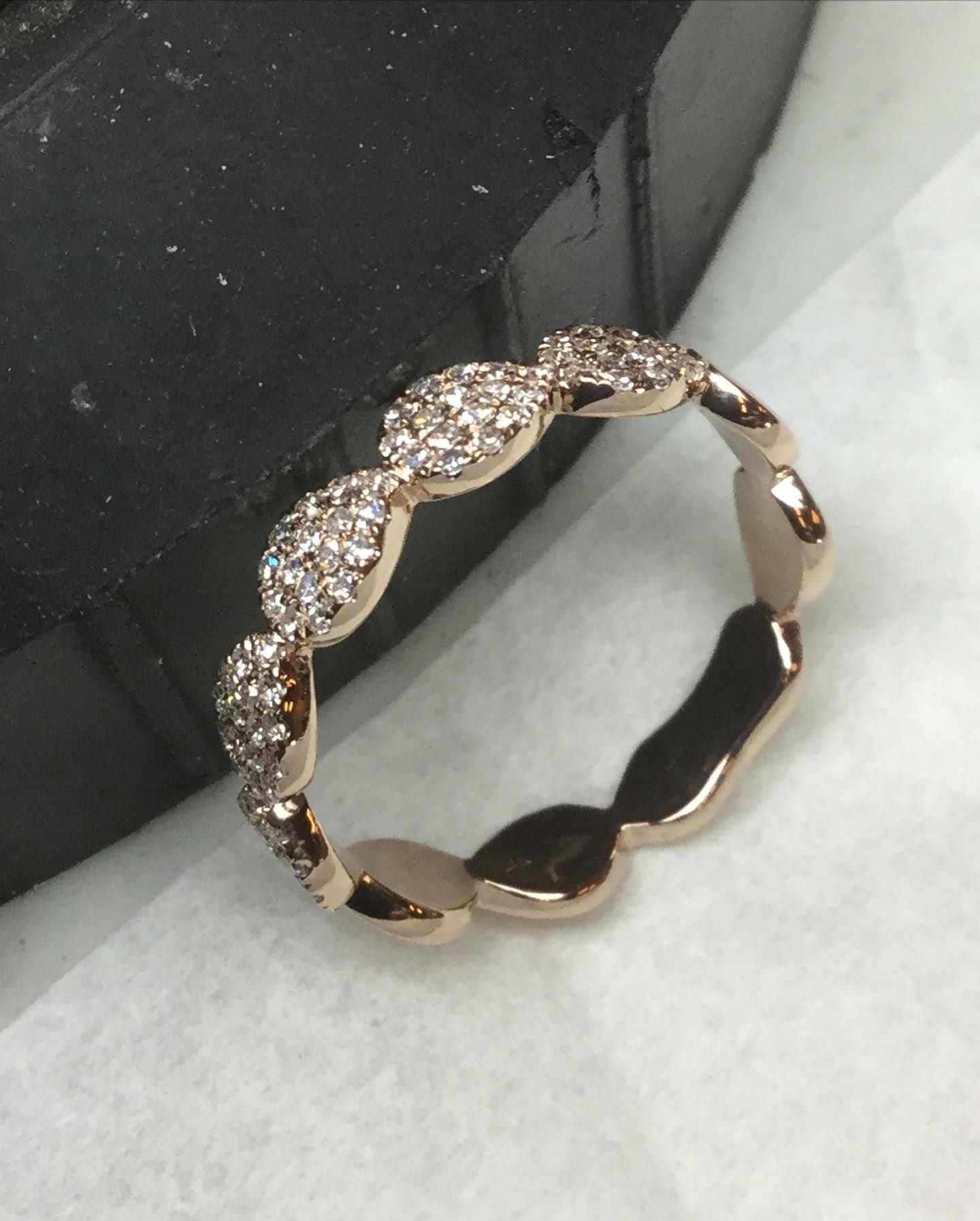 A close up of a ring with diamonds on it