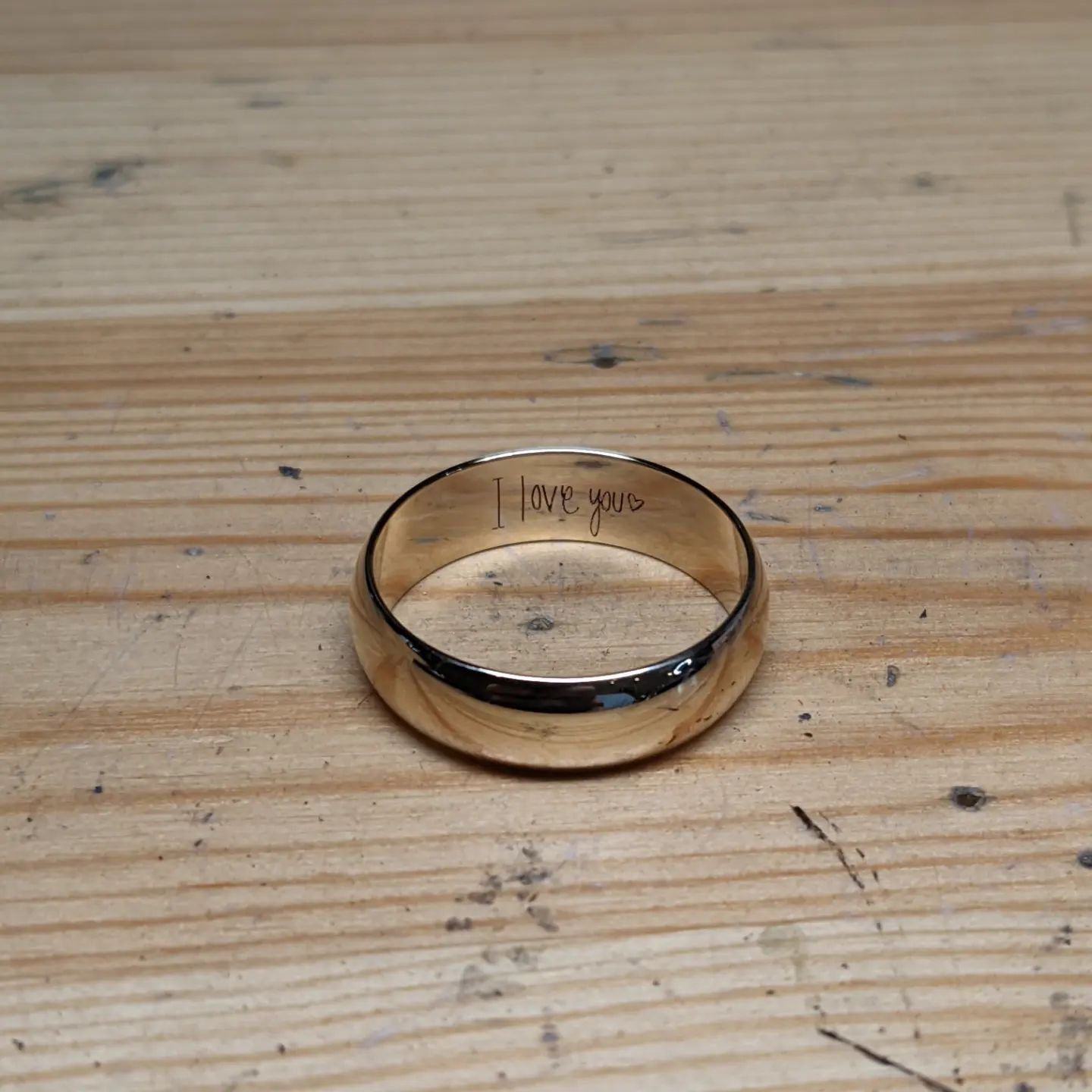 A gold ring with the words 