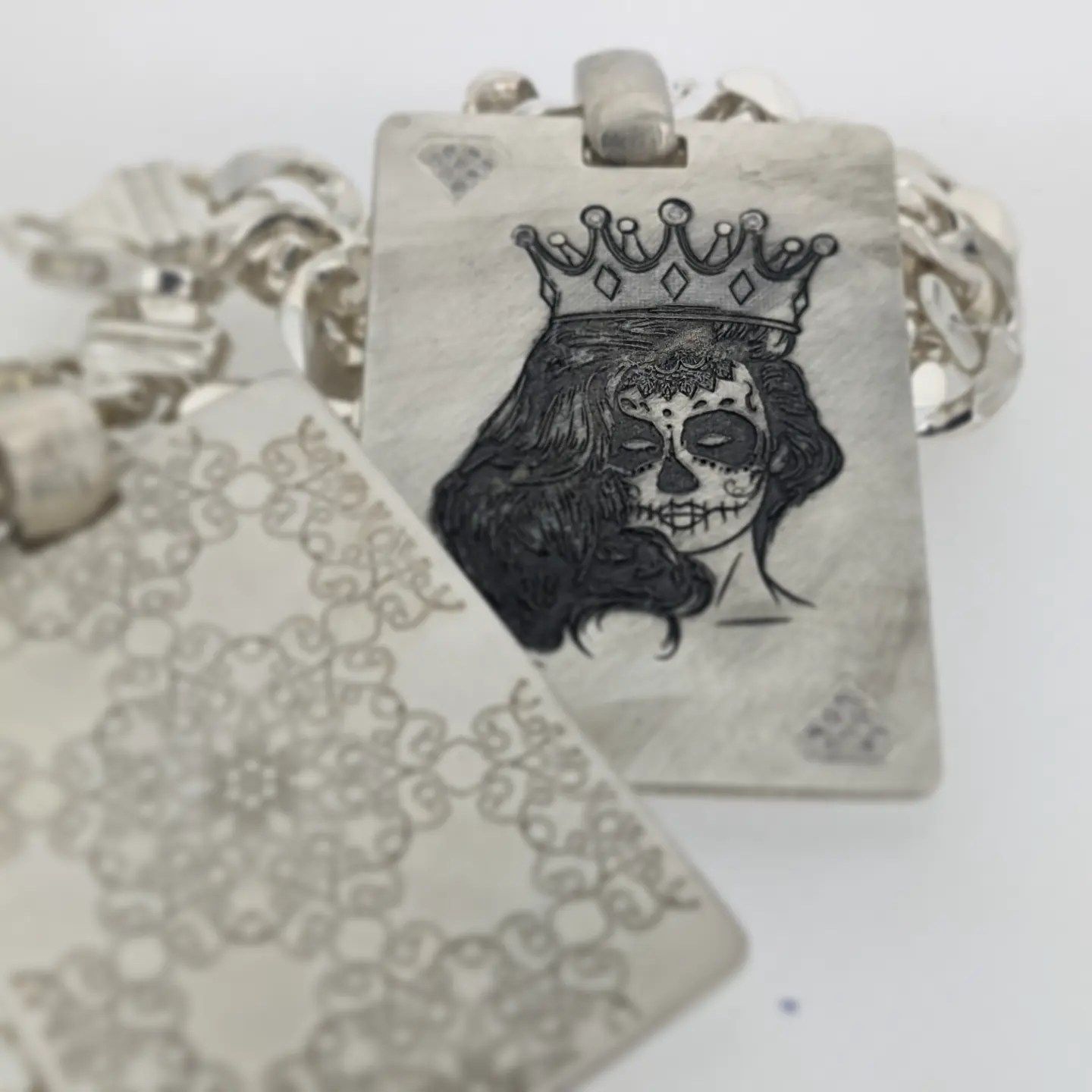 A necklace with a picture of a woman with a crown on her head