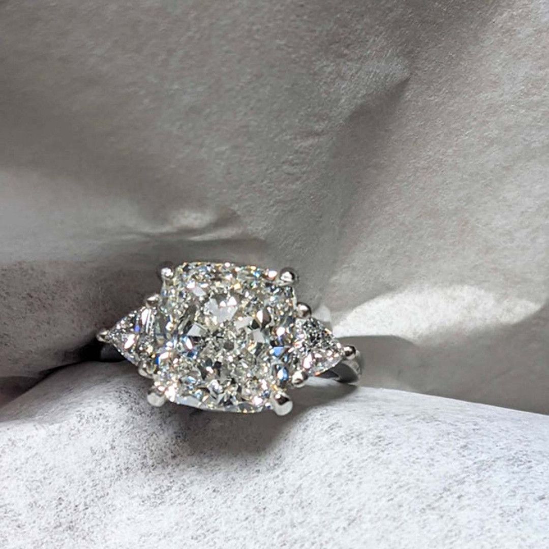 A diamond ring is sitting on top of a piece of paper.