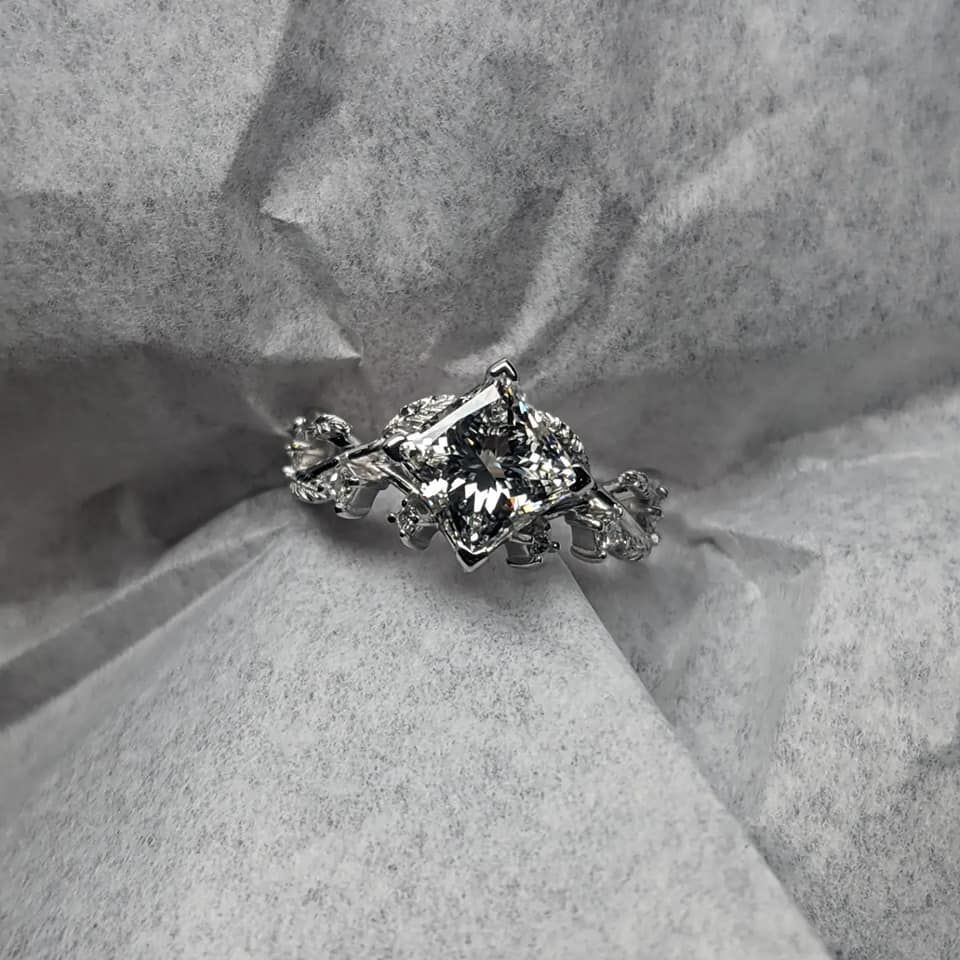 A silver ring is laying on a piece of paper