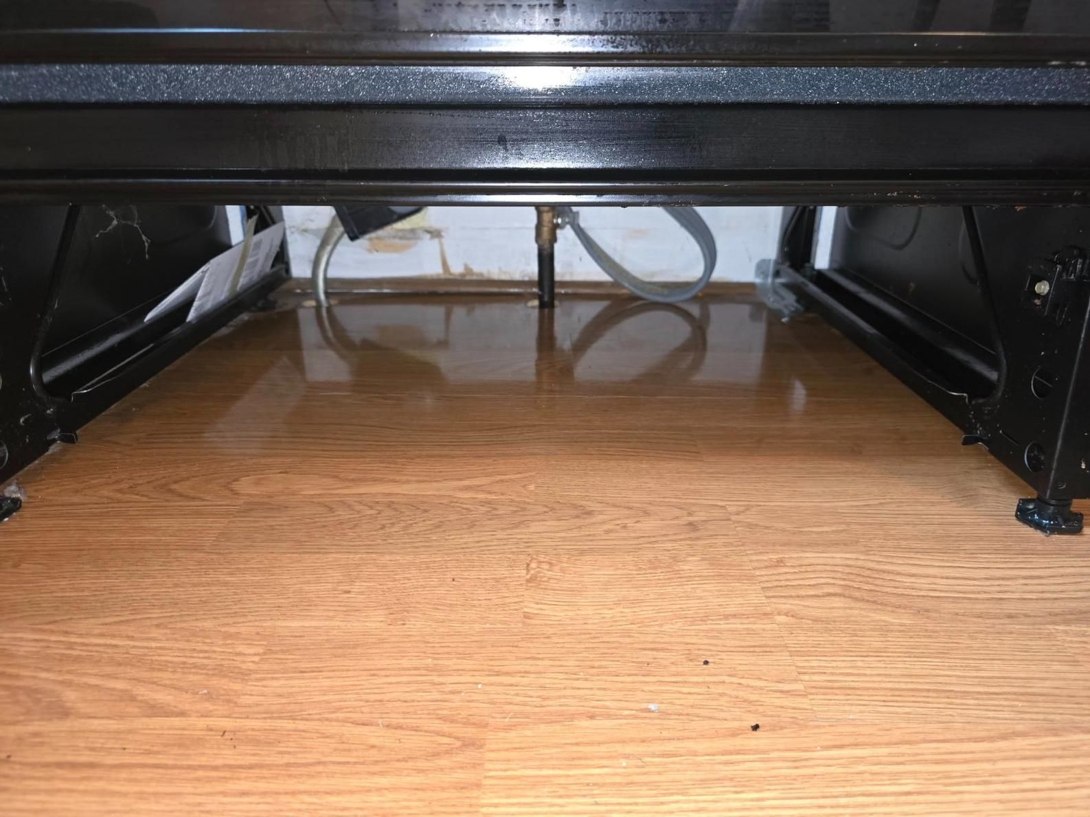 Before cleaning underside of a kitchen stove.