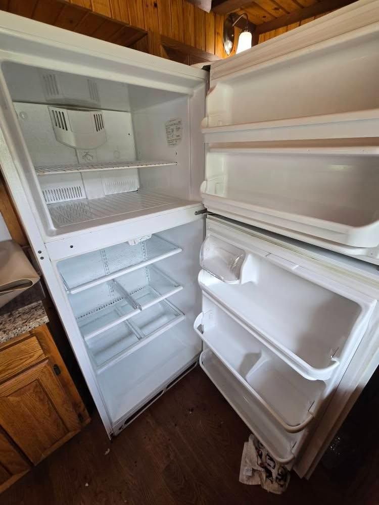 After cleaning white refrigerator in a kitchen.