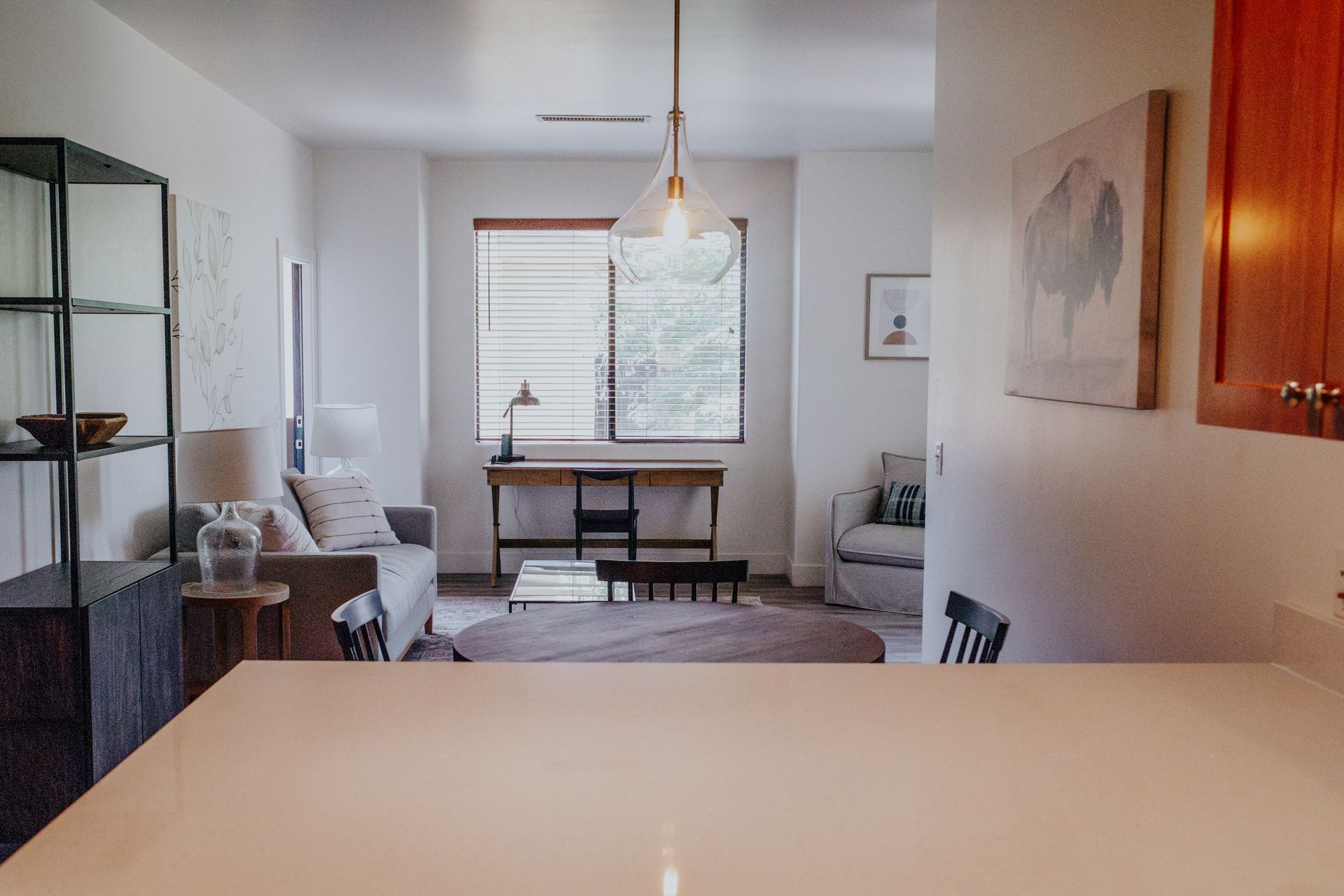 Modern open-concept dining and living area with natural light and stylish decor.