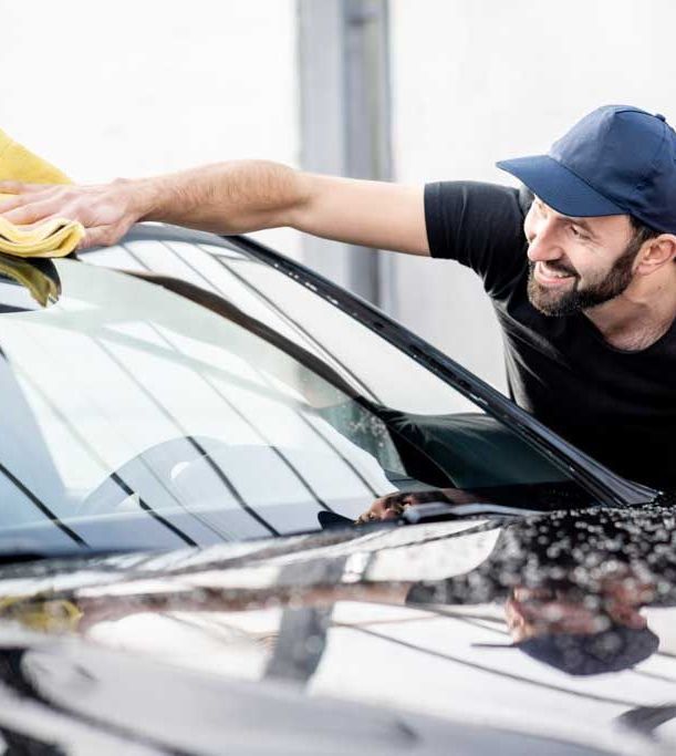 Dan washing car smiling