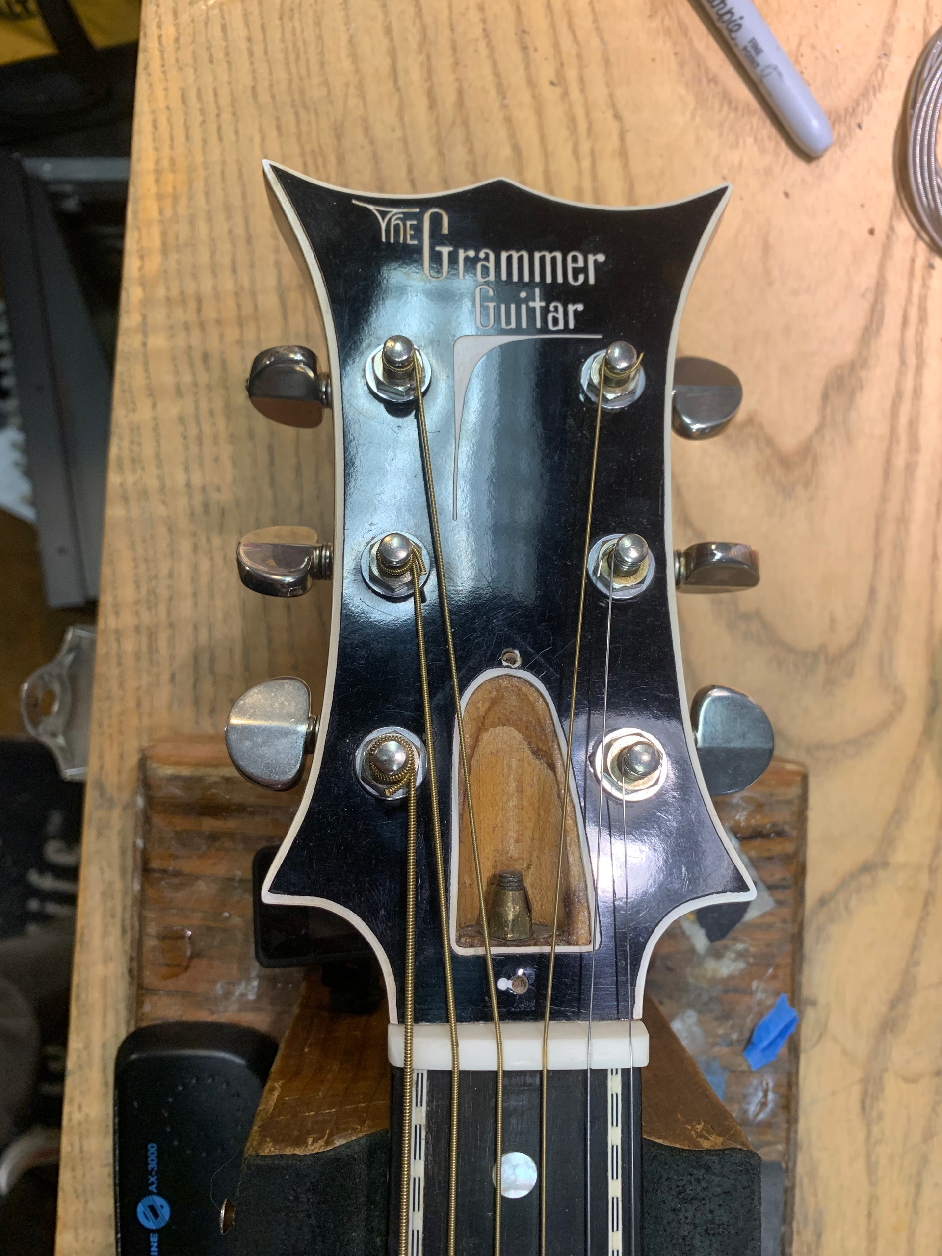Guitar headstock with tuning pegs.