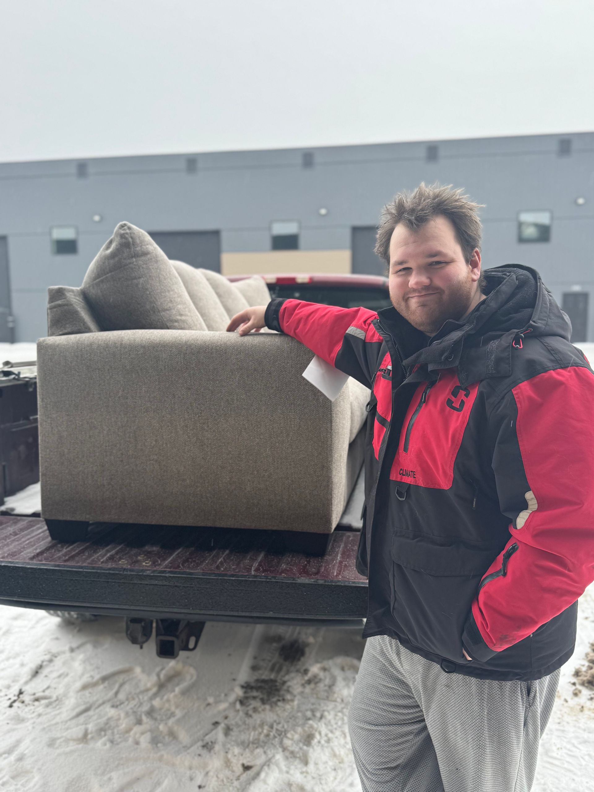 Brown leather sofa with two matching pillows, showroom.
