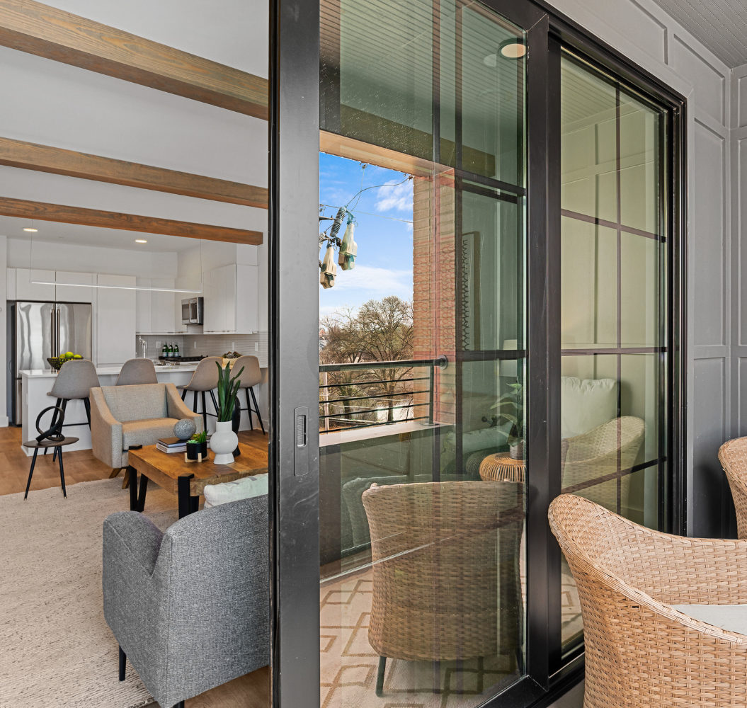 A living room with sliding glass doors leading to a balcony.