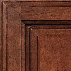 Close-up of a wooden cabinet door with a rich brown stain and framed panel design.