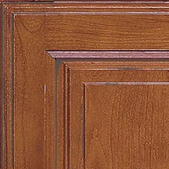 Close-up of a brown wooden cabinet door with layered detailing, showcasing the wood grain texture.