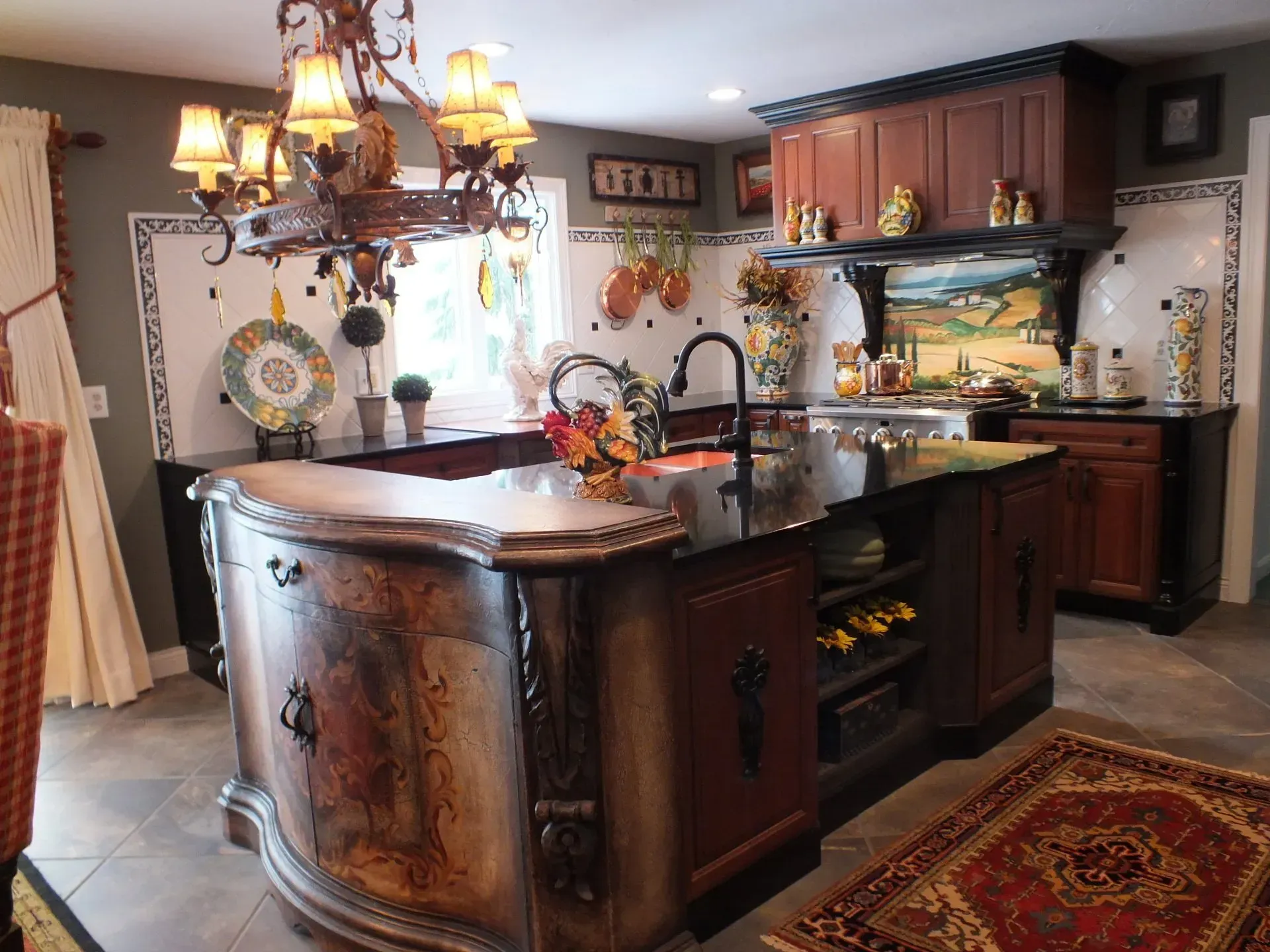 Elegant kitchen with ornate island, dark cabinets, and colorful backsplash tiles.