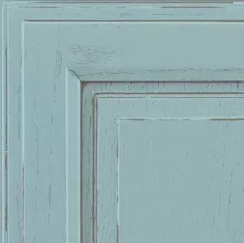 Light blue cabinet door with distressed finish, showing panel details.