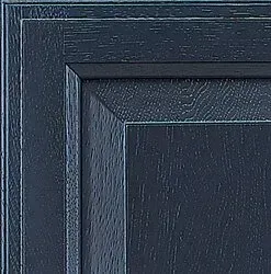 Close-up of a dark blue wooden cabinet door, showing the corner and wood grain texture.