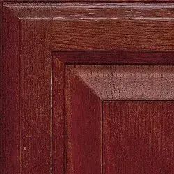 Dark reddish-brown wooden cabinet door with visible grain.